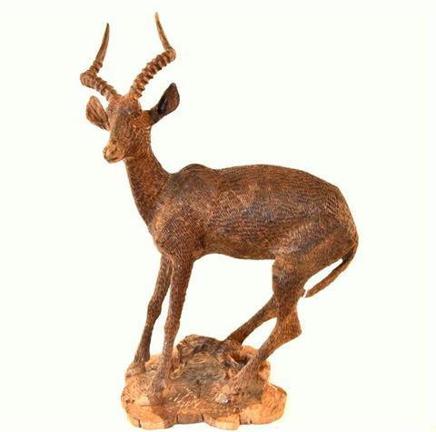 hand carved sculpture of an impala